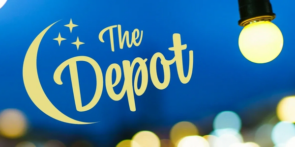Logo of 'The Depot' with a crescent moon and stars on a blue background with lights.