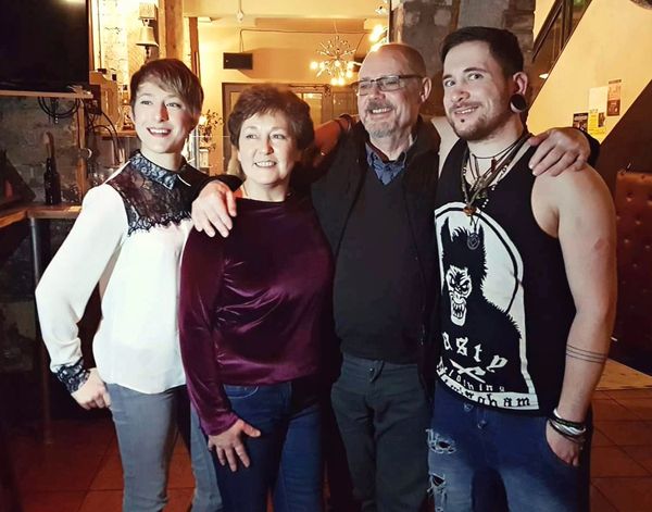 Pete standing with his parents and sister in bar at his EP launch