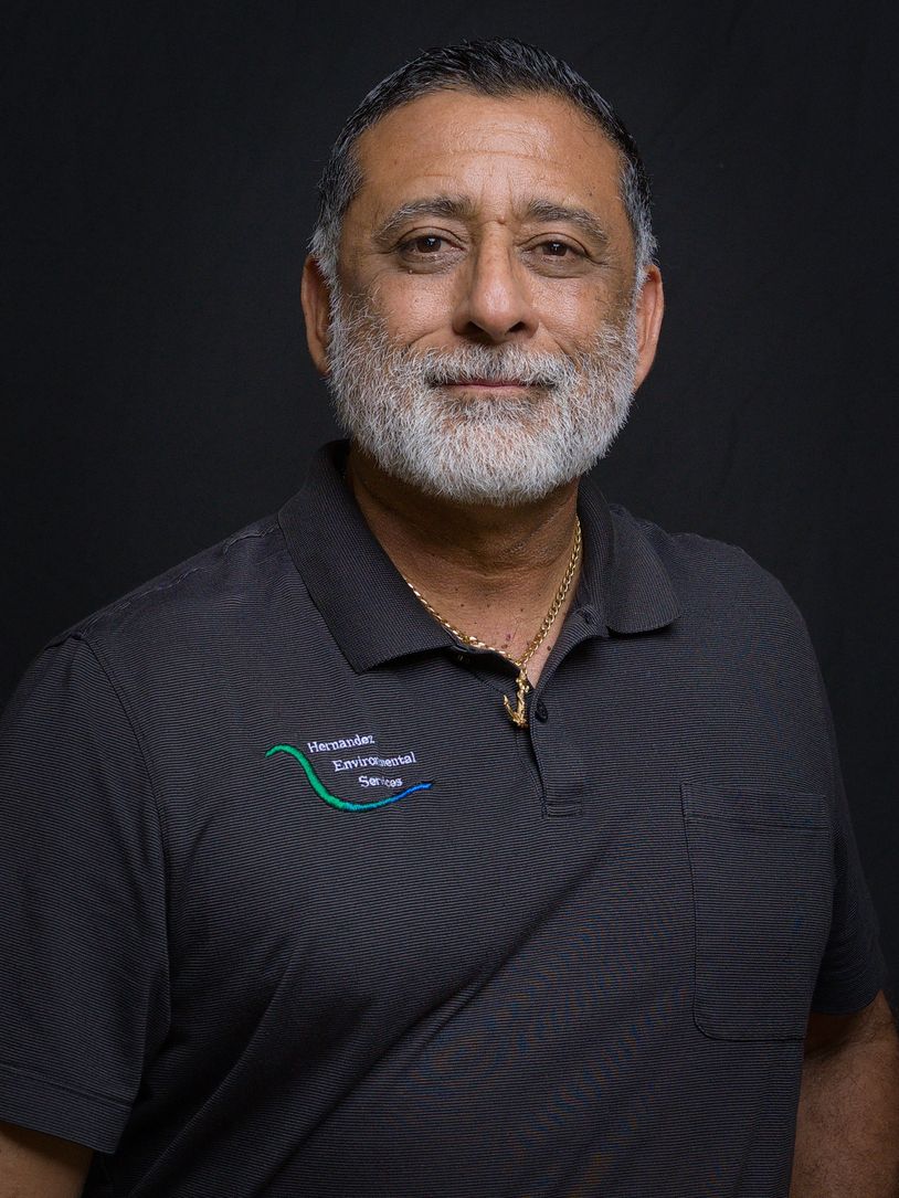 Smiling man in a polo shirt with company logo.