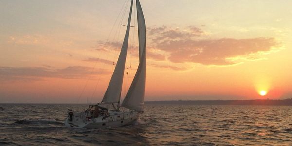 A sailboat sailing into the sunset