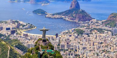 Aerial view of Rio de Janeiro with Christ the Redeemer statue and Sugarloaf Mountain.