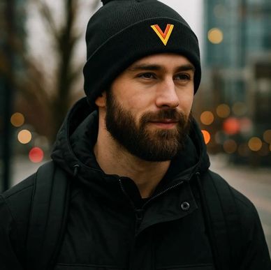 A guy wearing a Vancouver Canucks Flying Skate Flying V pom pom beanie