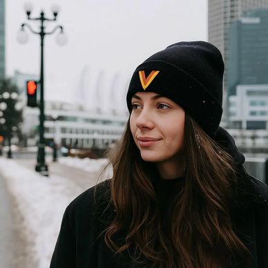 A girl wearing a Vancouver Canucks Flying Skate Flying V Beanie