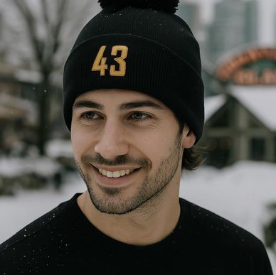 A guy wearing a Vancouver Canucks Flying Skate 43 beanie
