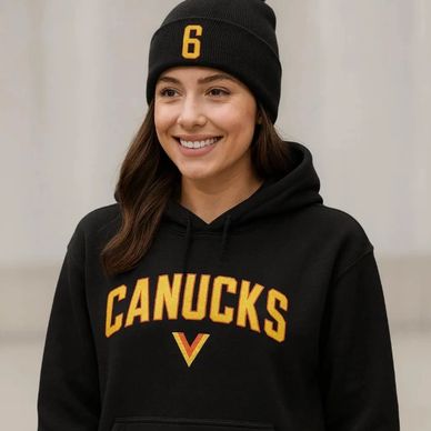 A girl wearing a Vancouver Canucks Flying Skate hoodie with the Flying V on the front 
