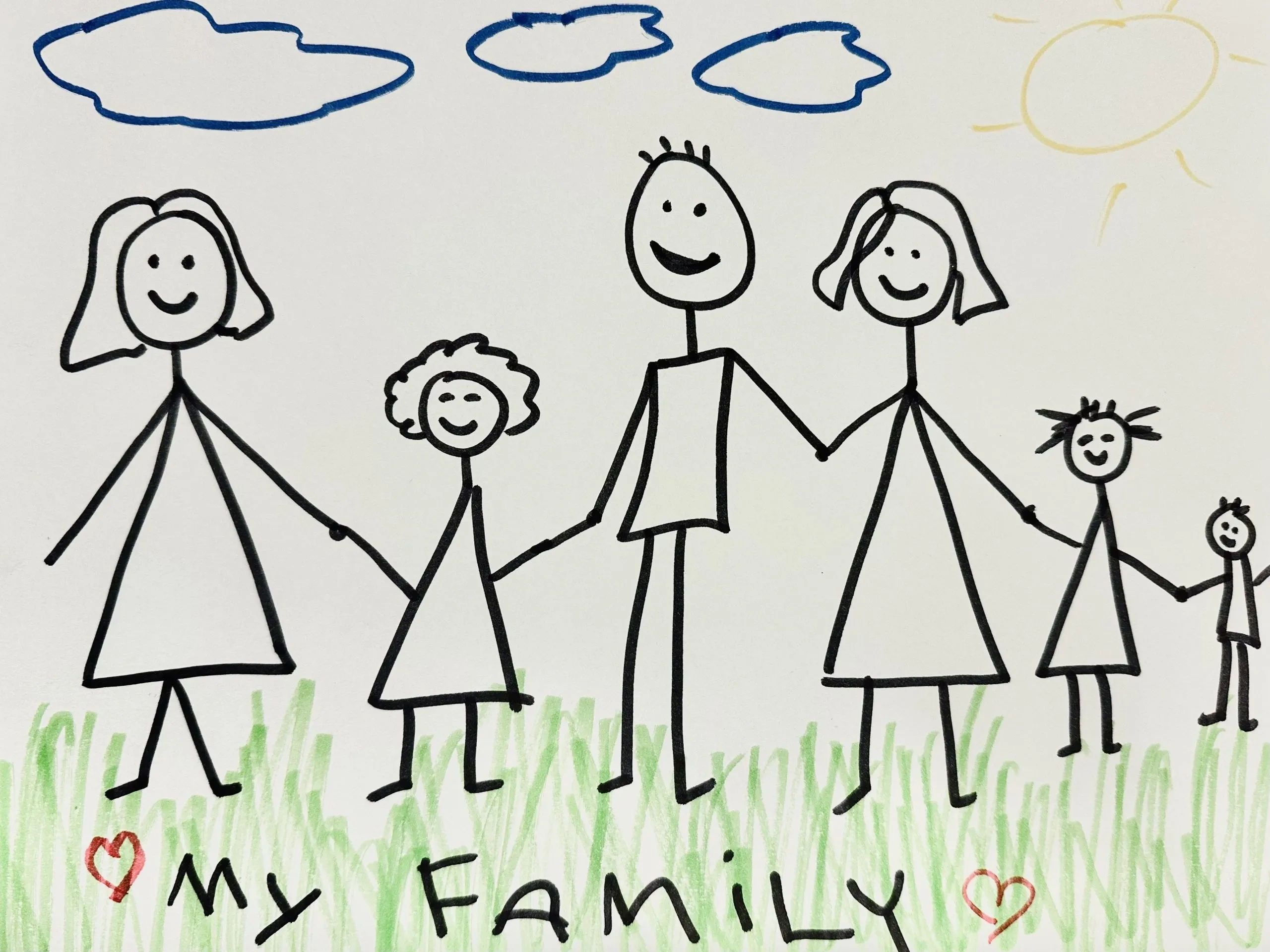 Stick figure drawing of a happy family holding hands outside.