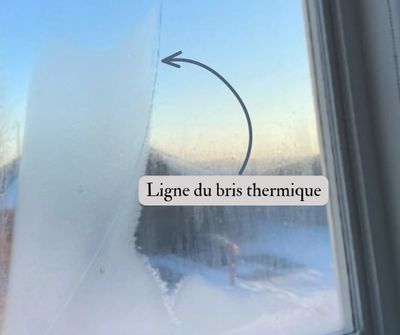 Crack in window glass labeled as thermal break line.