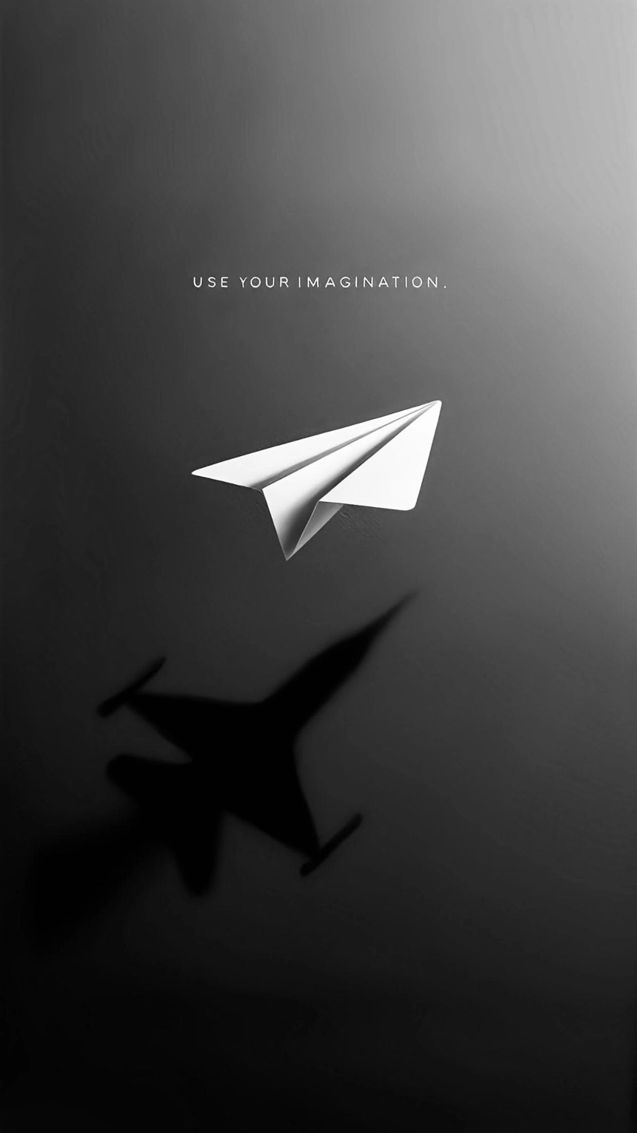 Paper plane casting a shadow of a real airplane with the words 'Use your imagination.'