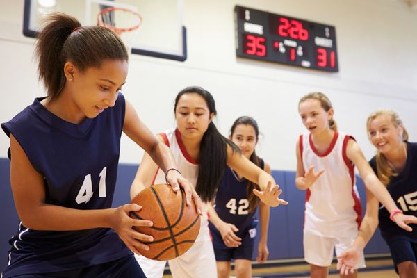A young basketball player with number 41 dribbles.