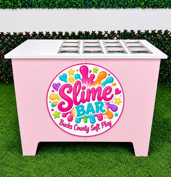 Colorful slime bar station outdoors on grass.