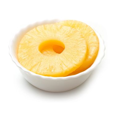 Two pineapple rings in a white bowl.