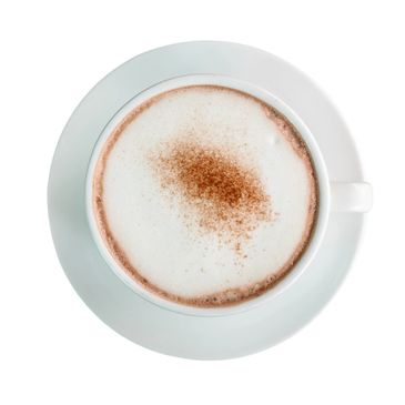 Top view of a cappuccino with frothy milk and cocoa powder.