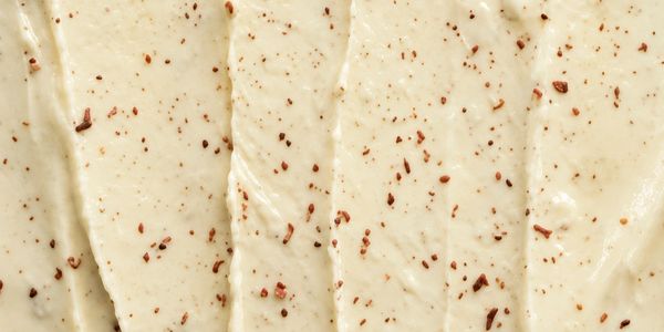 Close-up of creamy vegan garlic cheese with grainy spices.