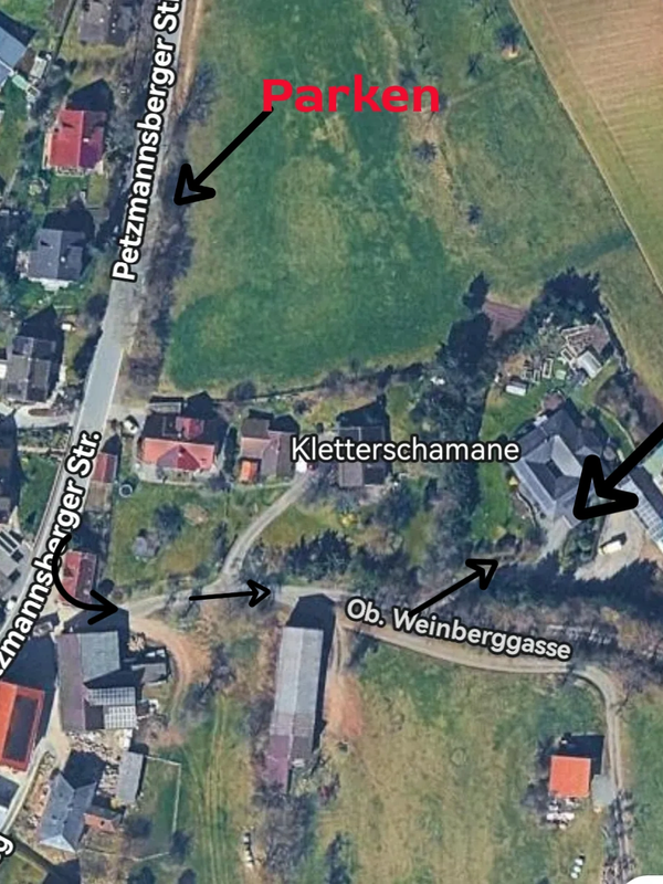 Aerial view of a rural area with streets labeled and parking marked in red.