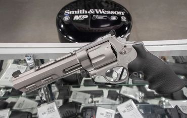 Smith & Wesson revolvers sitting on the counter. 