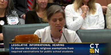 Woman speaking at a legislative hearing on vaccine exemptions.