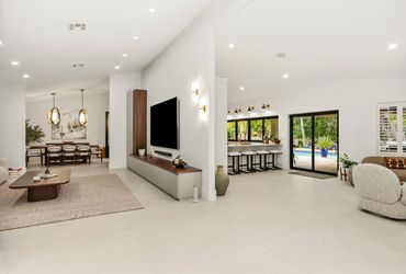 Modern open living space with kitchen and dining area.
