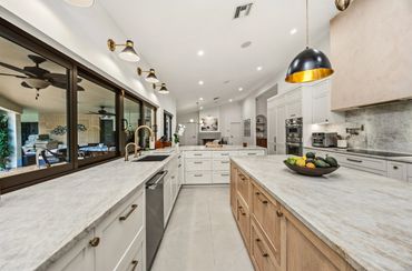Modern spacious kitchen with marble countertops.