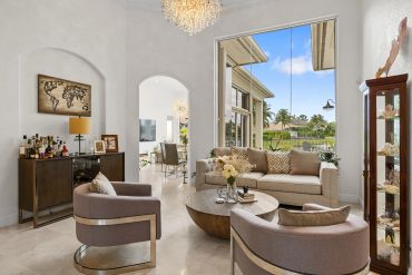 Bright living room with modern furniture and large windows.