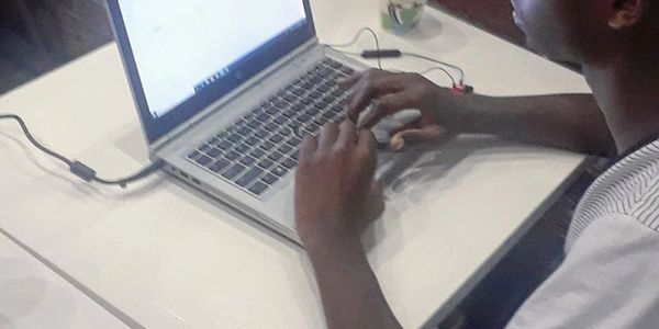 Person typing on a laptop at a desk.