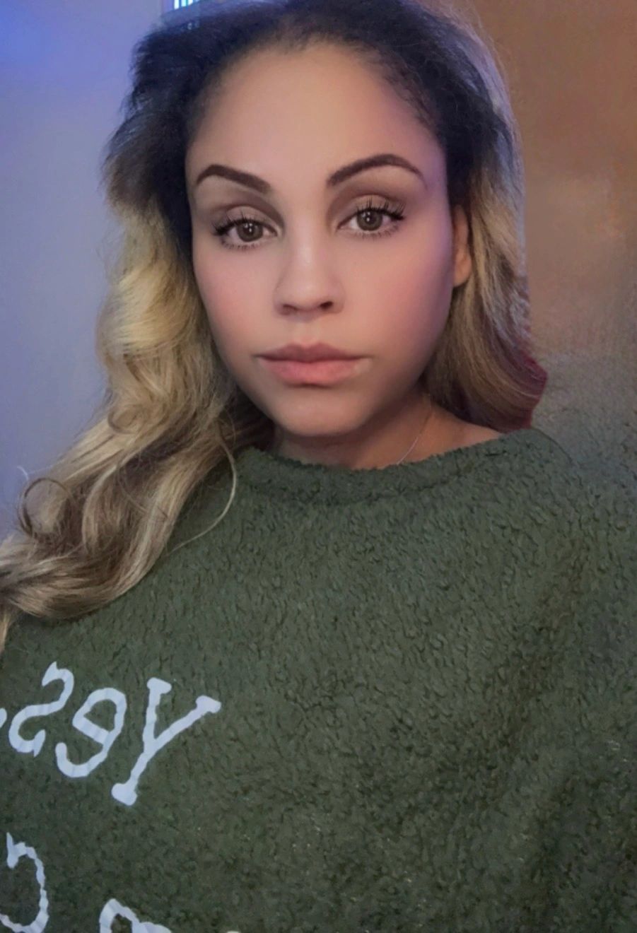 Stack of books next to pencils in a holder and a camera.