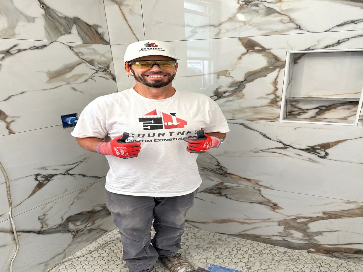Picture of General Contractor appearing very happy with the work in remodeled bathroom 