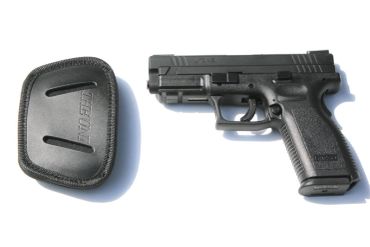 Black handgun and holster on white background.