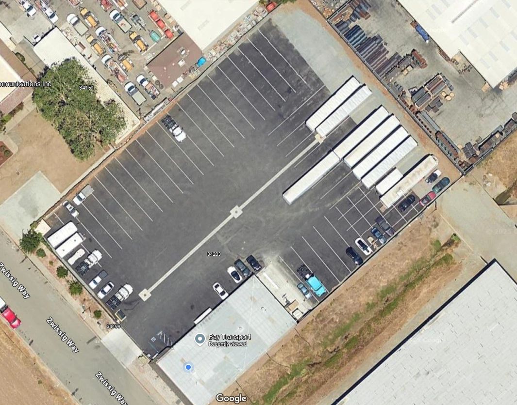Aerial view of a parking lot with trucks and cars at Bay Transport.