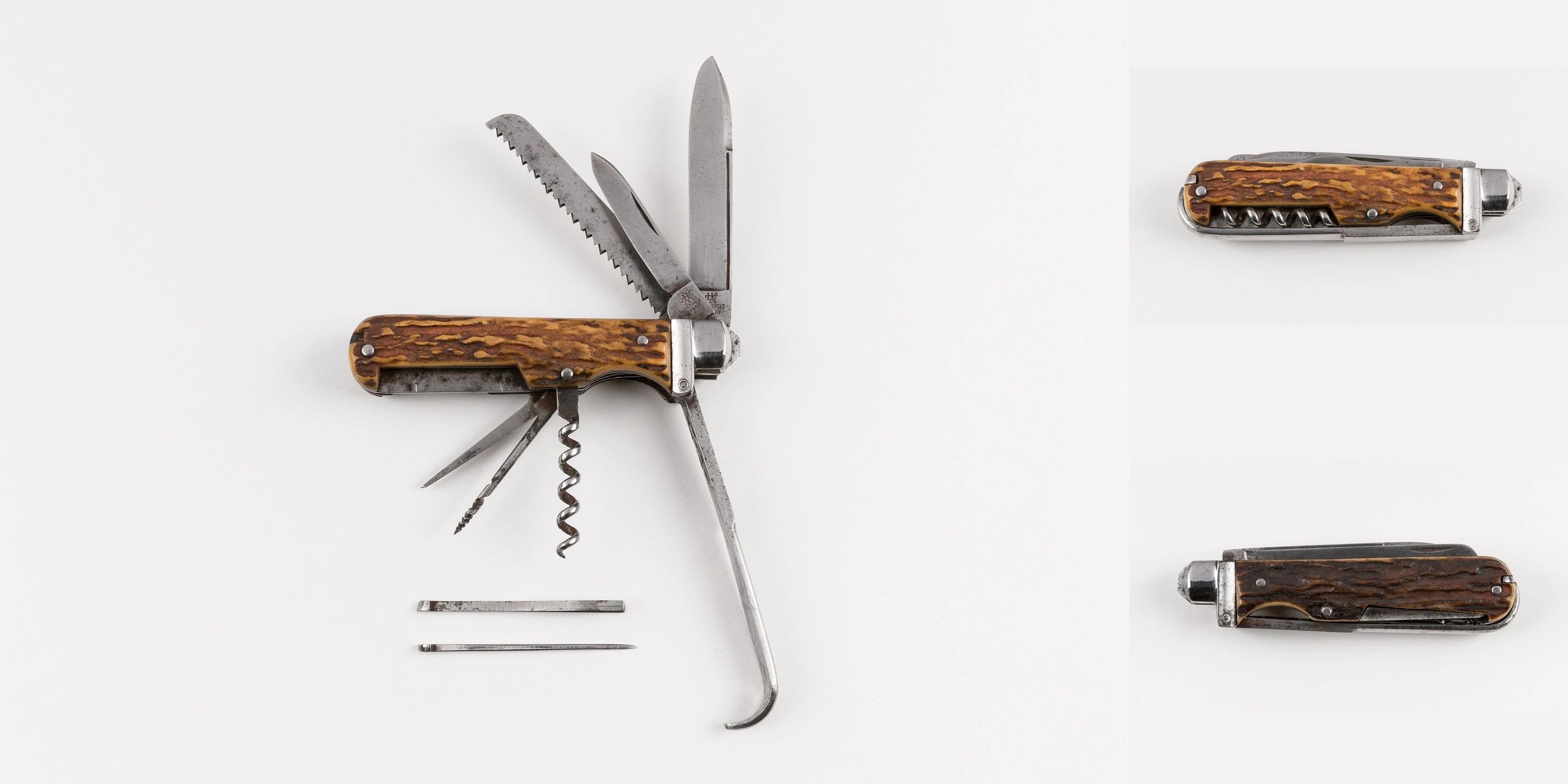 Vintage multi-tool pocket knife with wooden handle and various blades extended.