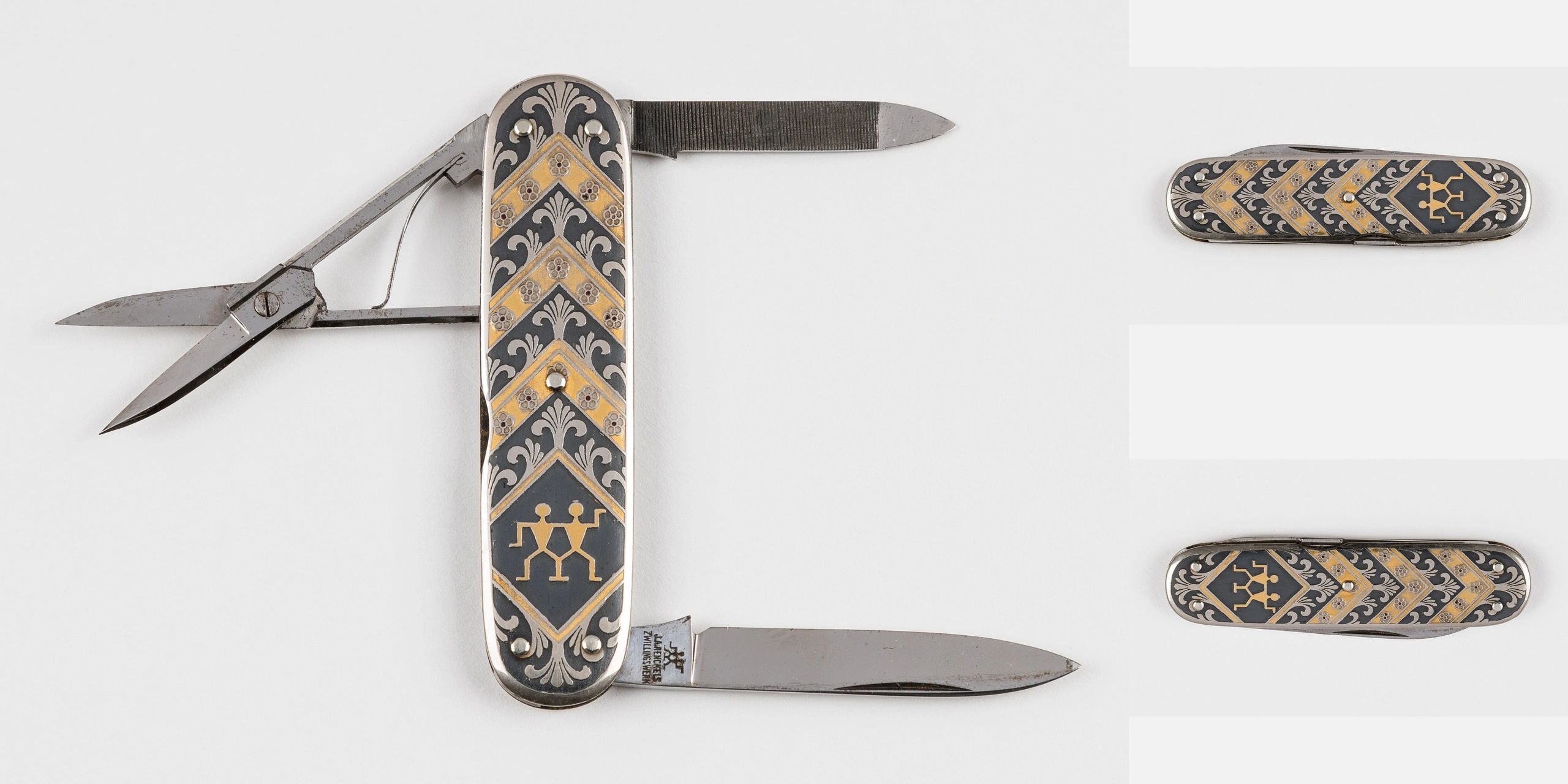 Decorative Swiss Army knife with gold and silver inlays and multiple tools.