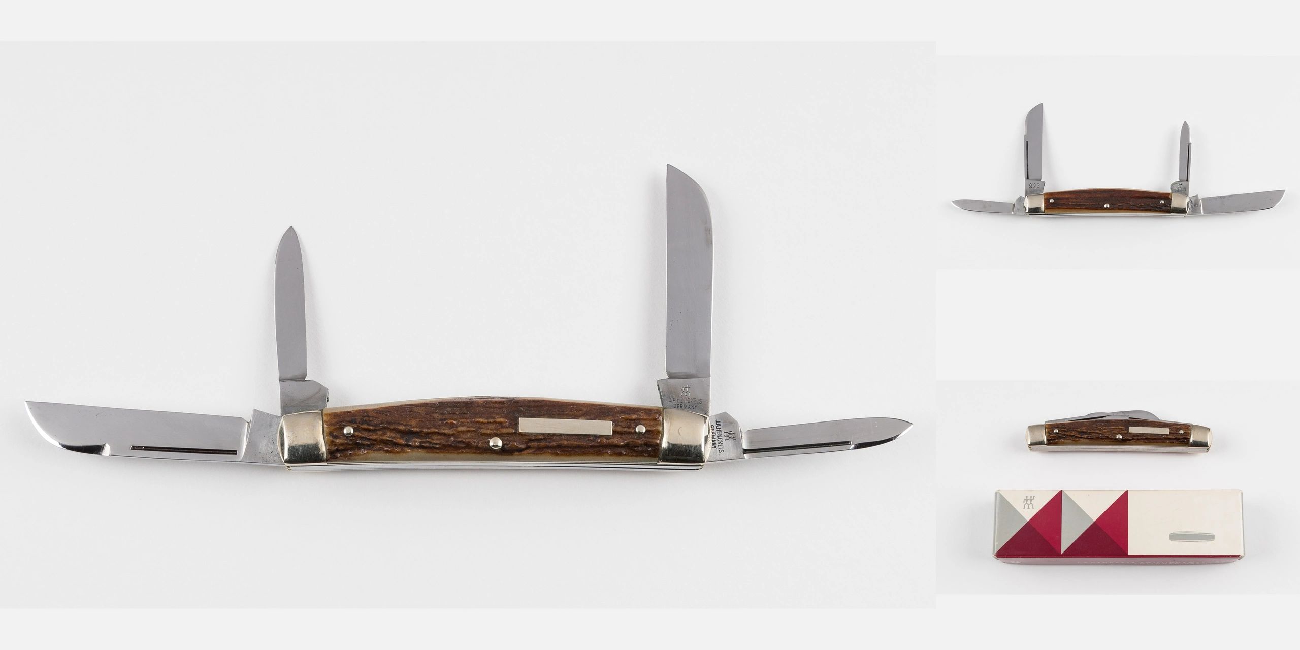 A vintage multi-blade pocket knife with wooden handle and metal bolsters.