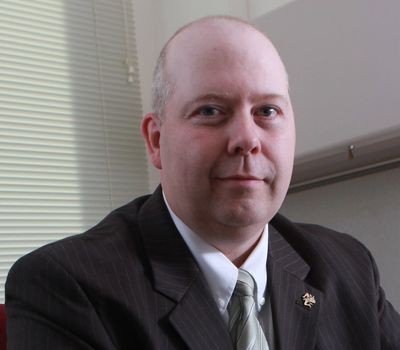 Man in a suit sitting in an office.
