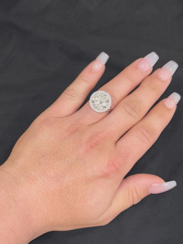 Hand with a large Bella Andrea & Co. CVD IGI graded lab grown 10 carat diamond ring on the ring finger.