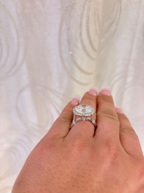 Hand wearing a sparkling Bella Andrea & Co. diamond ring with manicured nails.