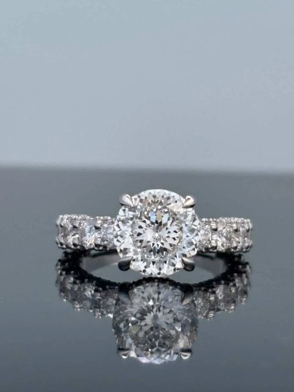 Elegant  Bella Andrea & Co. diamond ring with central round diamond and side stones.