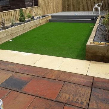 Composite Deck with Fencing and Raised beds planted out plus an  Artificial Lawn 30 mm  and Paving 