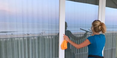 Woman cleaning glass in Ocean City Maryland