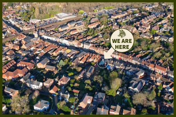 Aerial view of a suburban area marked with 'We Are Here'