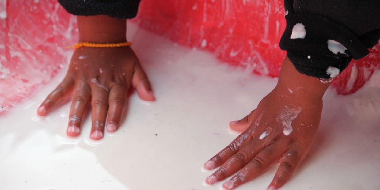 Preschool Childs Hands in sensory bin