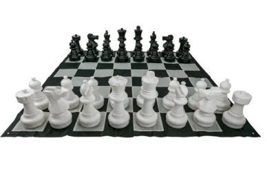 Large chess pieces set up on a board.