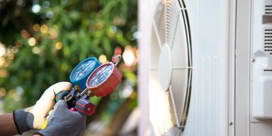 Truman's Air service technician checking refrigerant charge in a mini-split air conditioning system