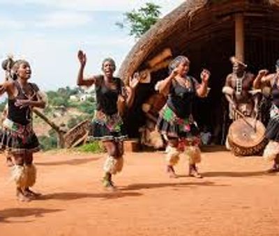 Traditional African dance performance with drummers and dancers in cultural attire.