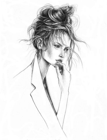 Pensive woman with messy bun, hand near mouth, wearing a jacket.