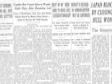 Blurred image of a newspaper page with unreadable text.