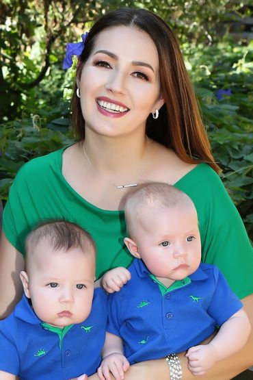 Photo of Mom and her two twin Babies in a garden.