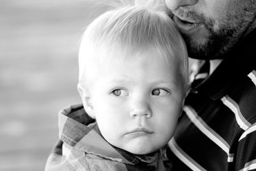 Family black & white Portrait of father and son in a sweet candid embrase