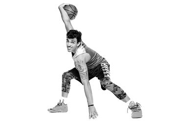 Senior photo of a male basketball player dribbling