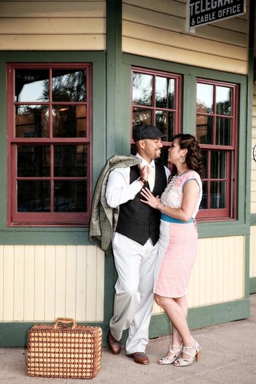 Romantic photo of a retro dressed couple at a train depot