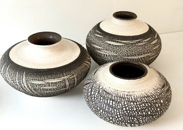 three black and white stoneware vases