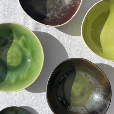 ceramic bowls in greens and plum colours